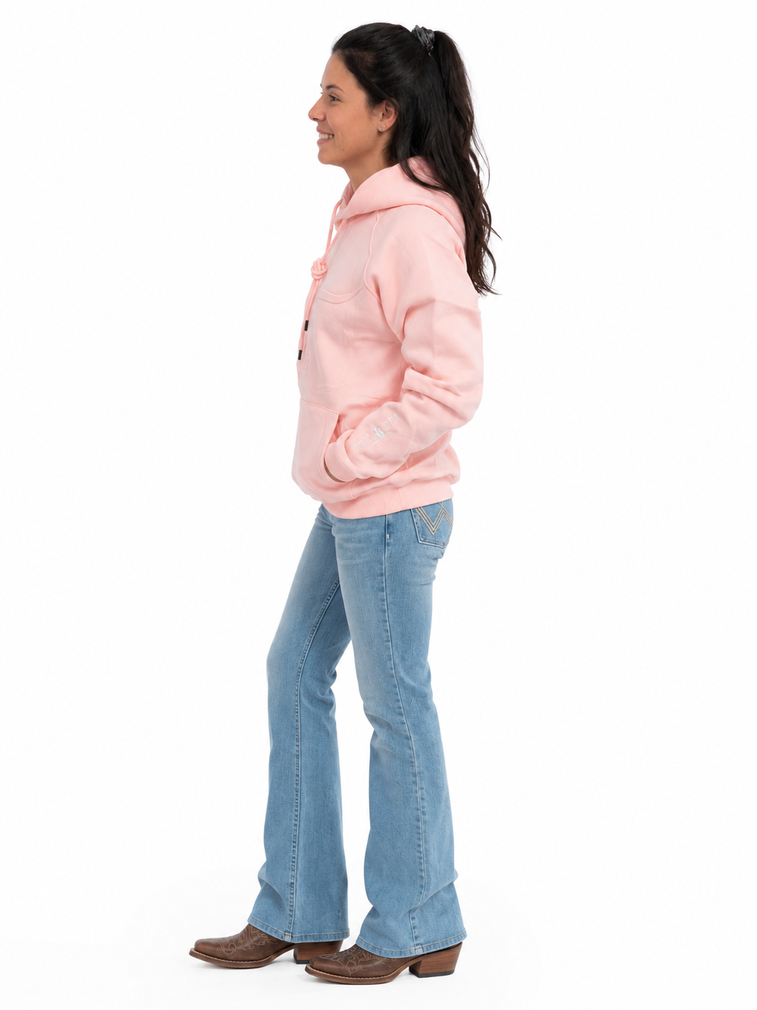 Woman wearing the Shack Story Embossed Skull dusty rose hoodie, side view